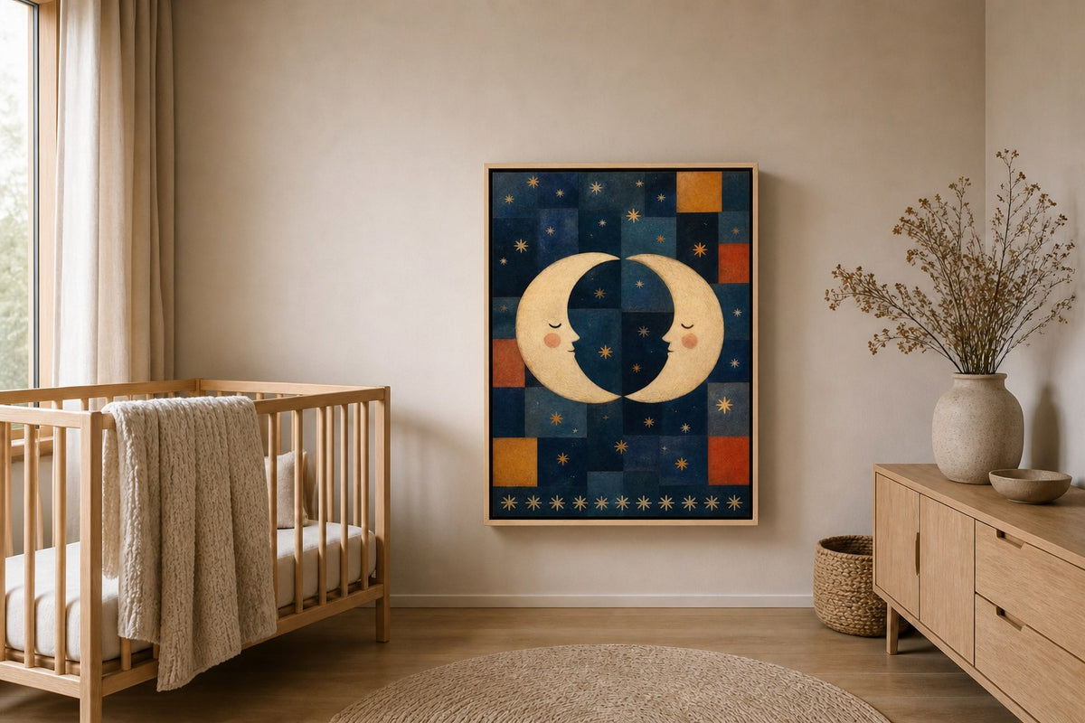 The Moon Sisters canvas in a natural light wood floater frame with a black inner edge, above a cot in a calm nursery