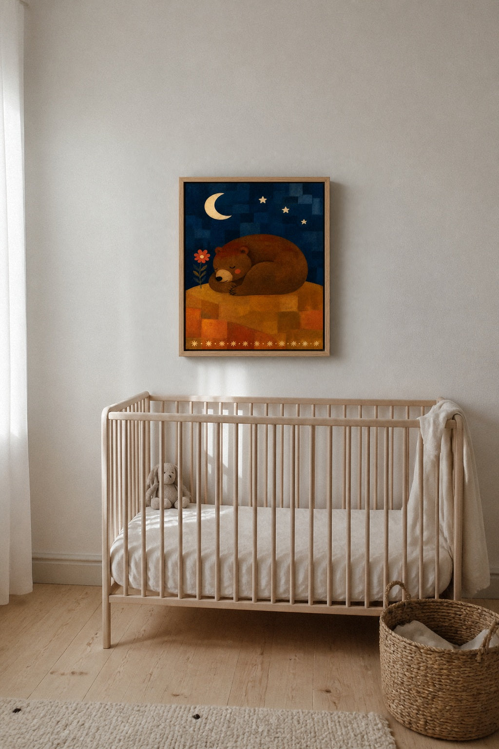 The Sleeping Bear canvas hanging above a cot in a nursery