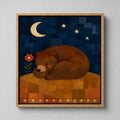 The Sleeping Bear folk art canvas in a natural light wood floater frame